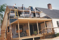 People constructing the roof area of a residential property